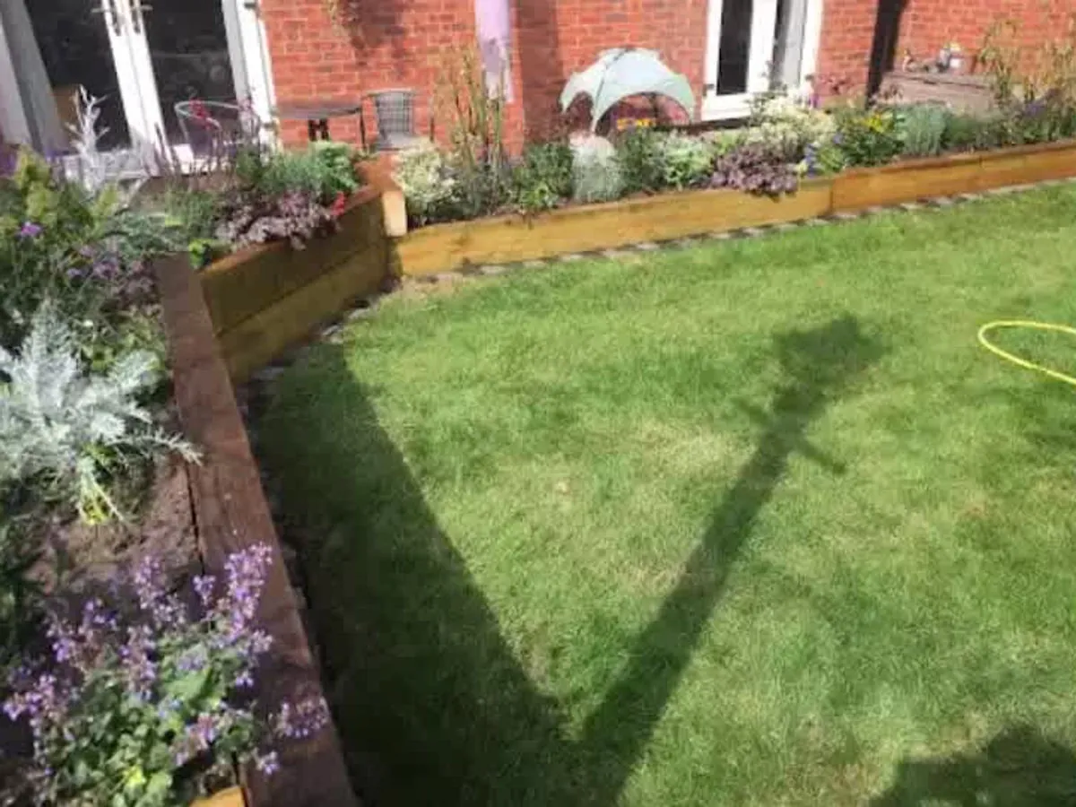 Lawn edged by timber raised planting beds