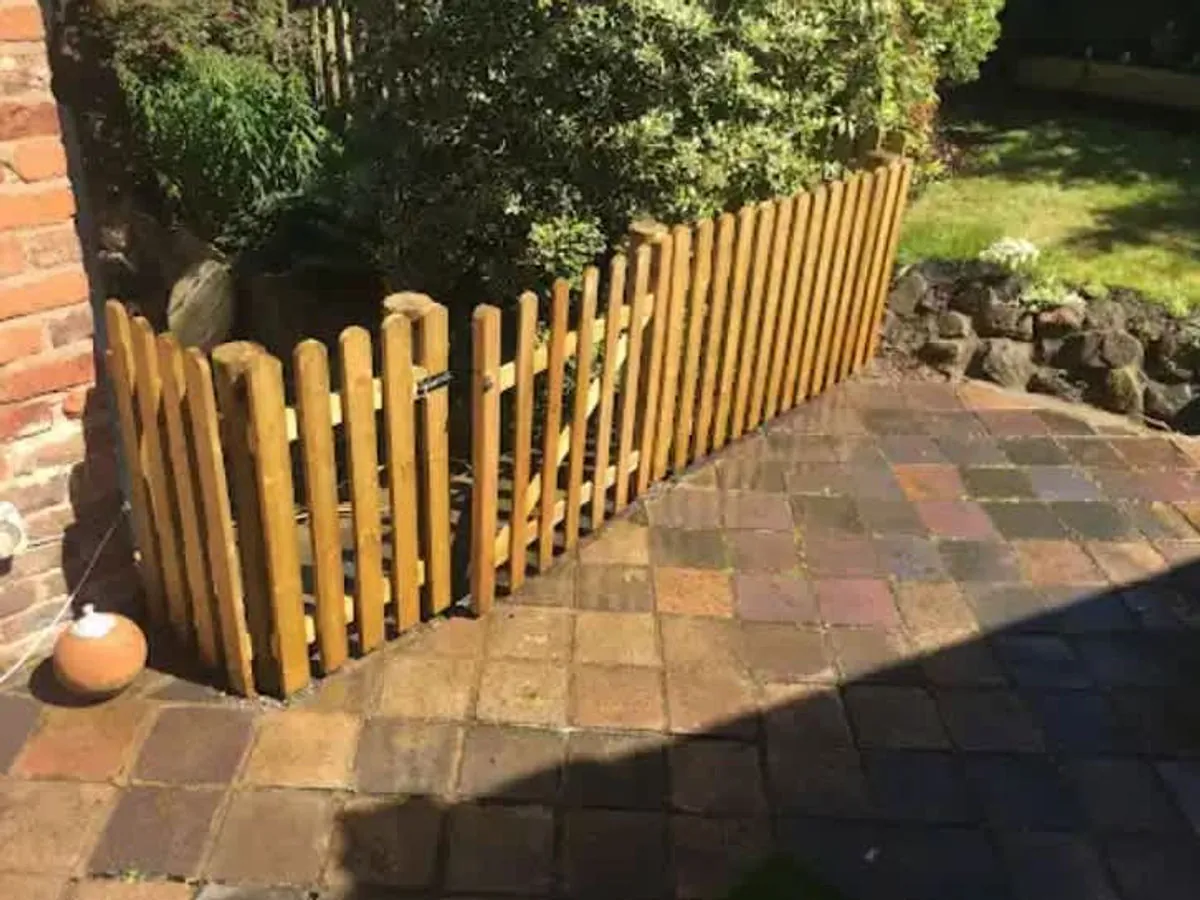 Paved garden access beside timber fencing
